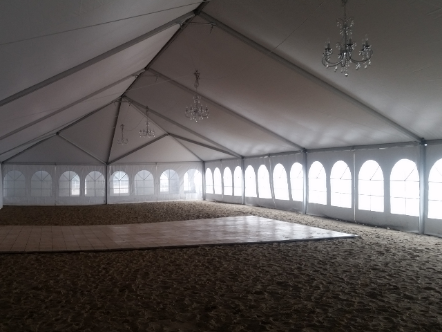 inside of a 40 ft. x 100 ft. Aztec Jumbotrac Frame Tent on a Lake Erie beach